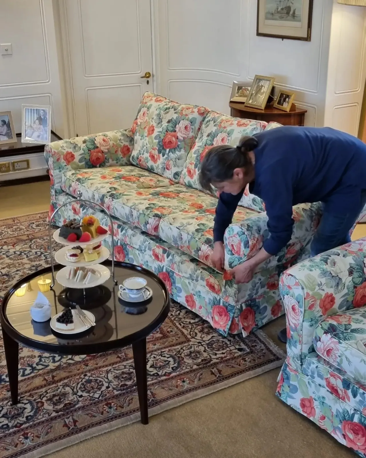 A reupholstered floral sofa being fitted aboard the Royal Yacht Britannia