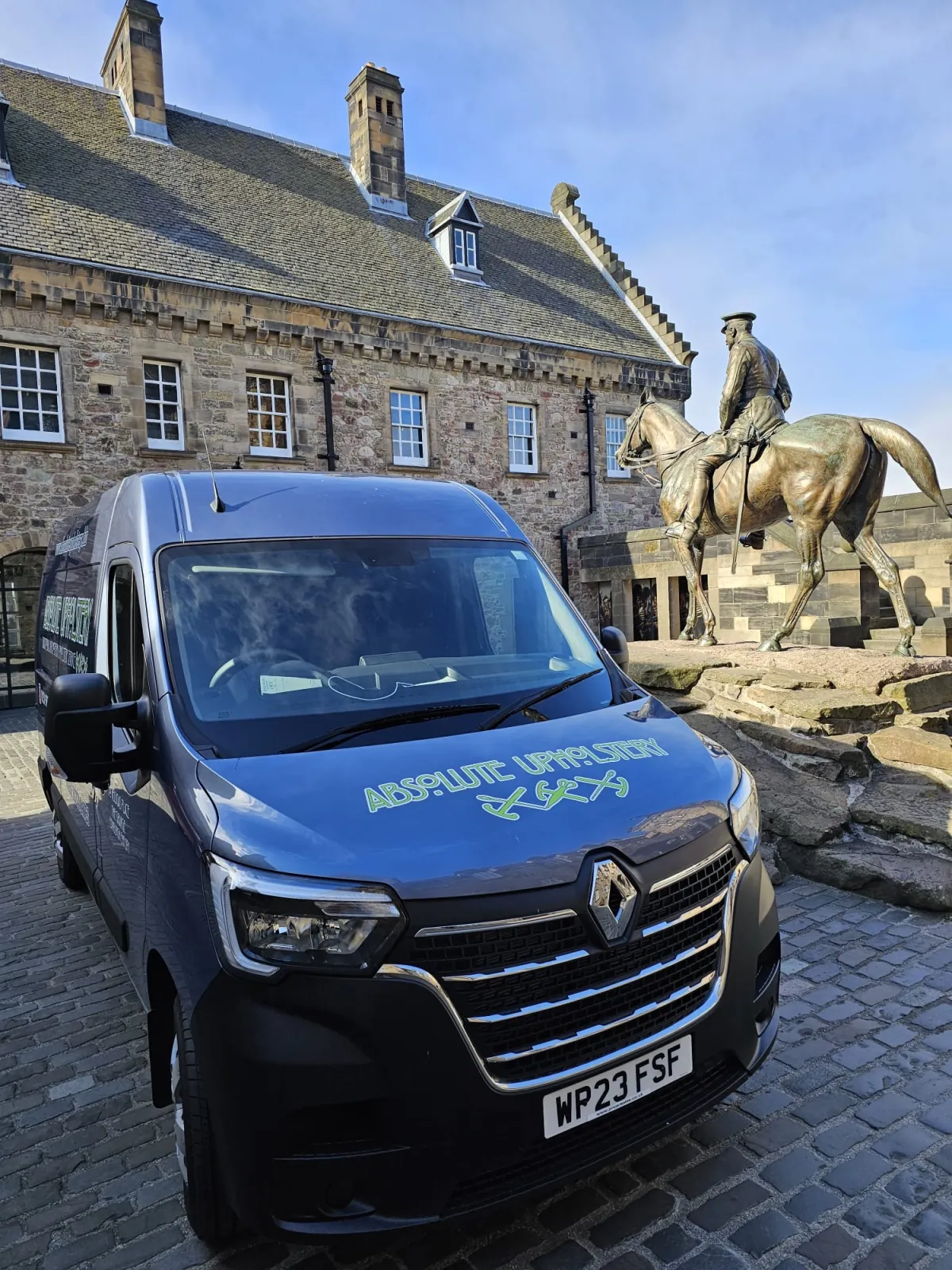 The Absolute Upholstery van parked at Edinburgh Castle beside the bronze equestrian statue