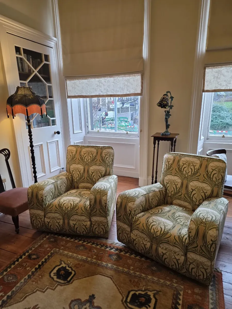 A pair of armchairs reupholstered in an art nouveau print