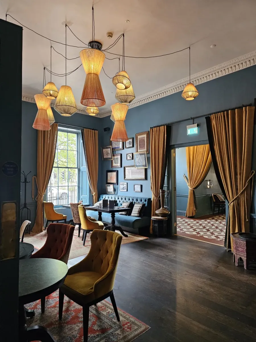 Velvet tub chairs and buttoned bench seating in a bar lounge