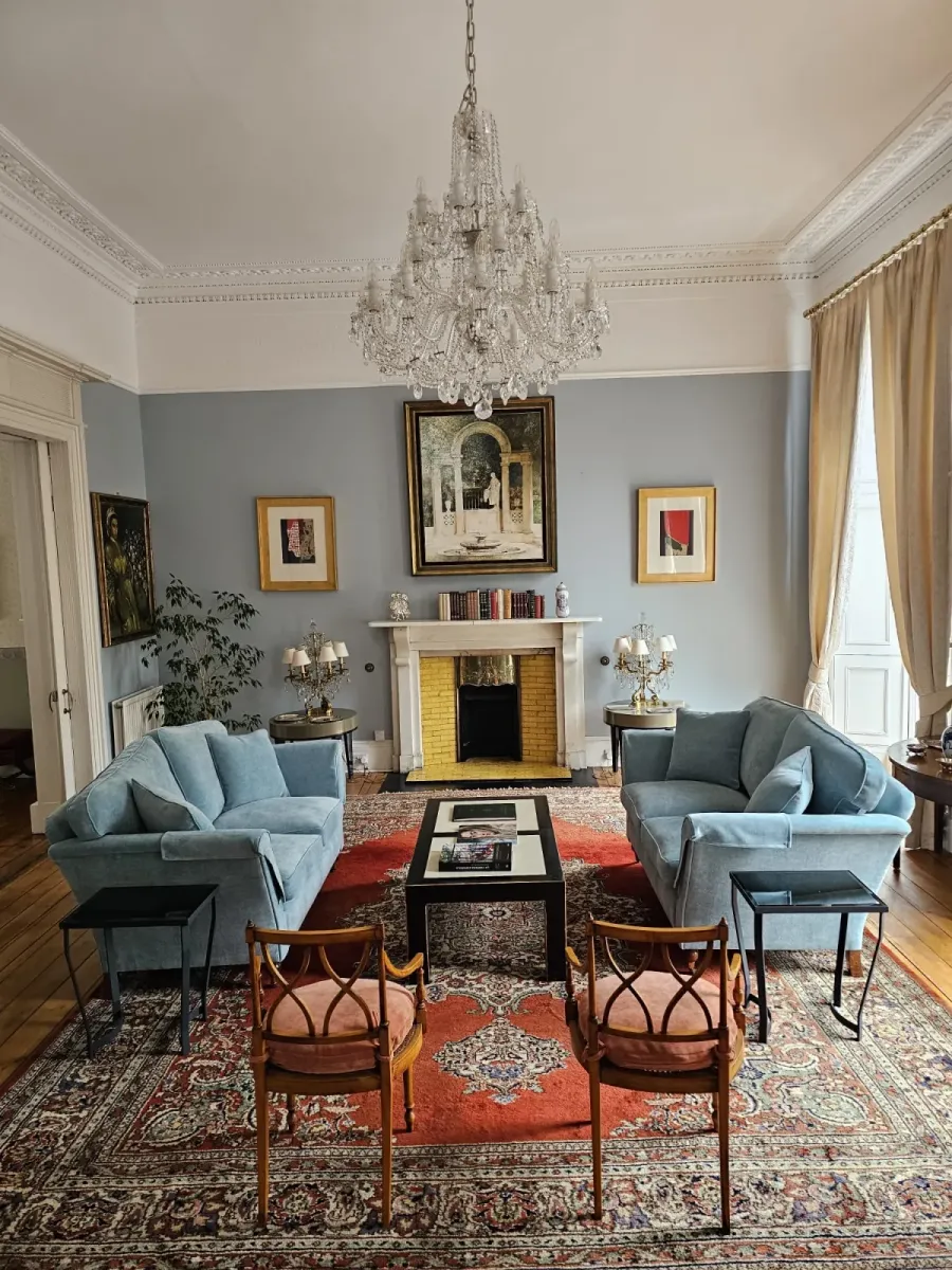 A pair of sofas reupholstered in pale blue velvet in a period drawing room