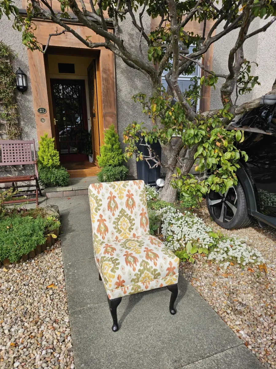 Occasional chair reupholstered in a cream and terracotta ikat weave