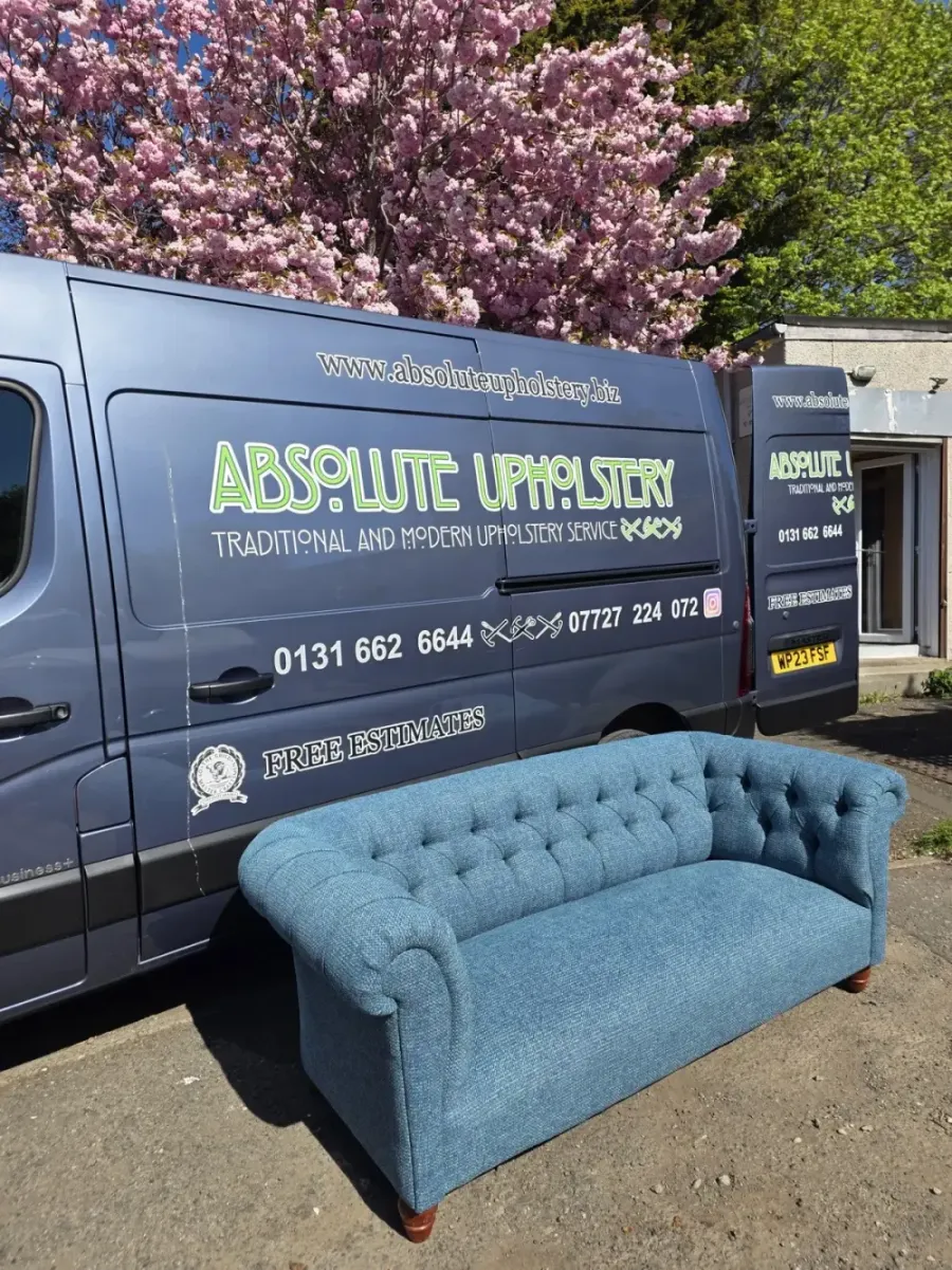 Modern deep-buttoned sofa reupholstered, with the Absolute Upholstery vans behind