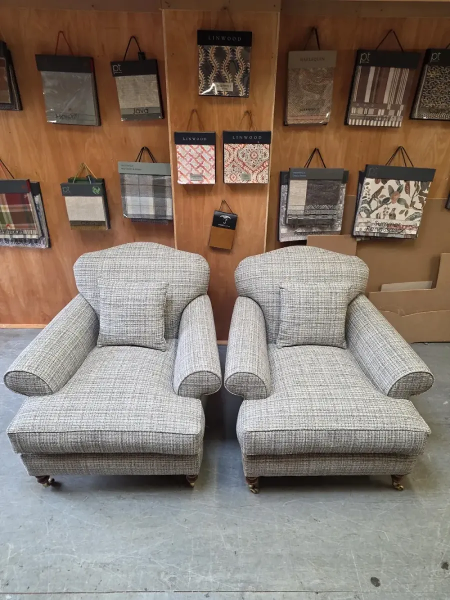 A pair of oversized armchairs reupholstered