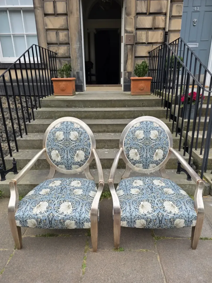 A pair of armchairs reupholstered in William Morris fabric