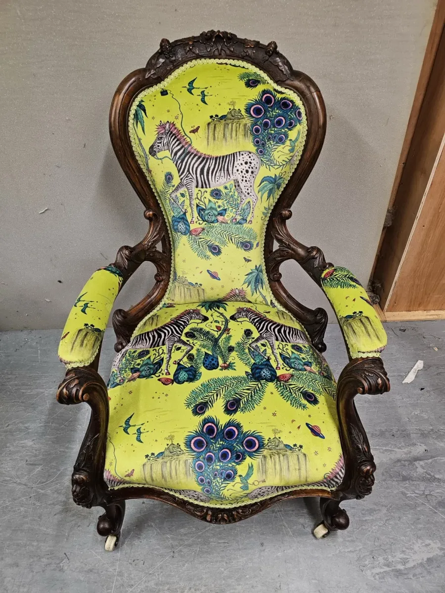 Carved Victorian nursing chair reupholstered in a bold animal print