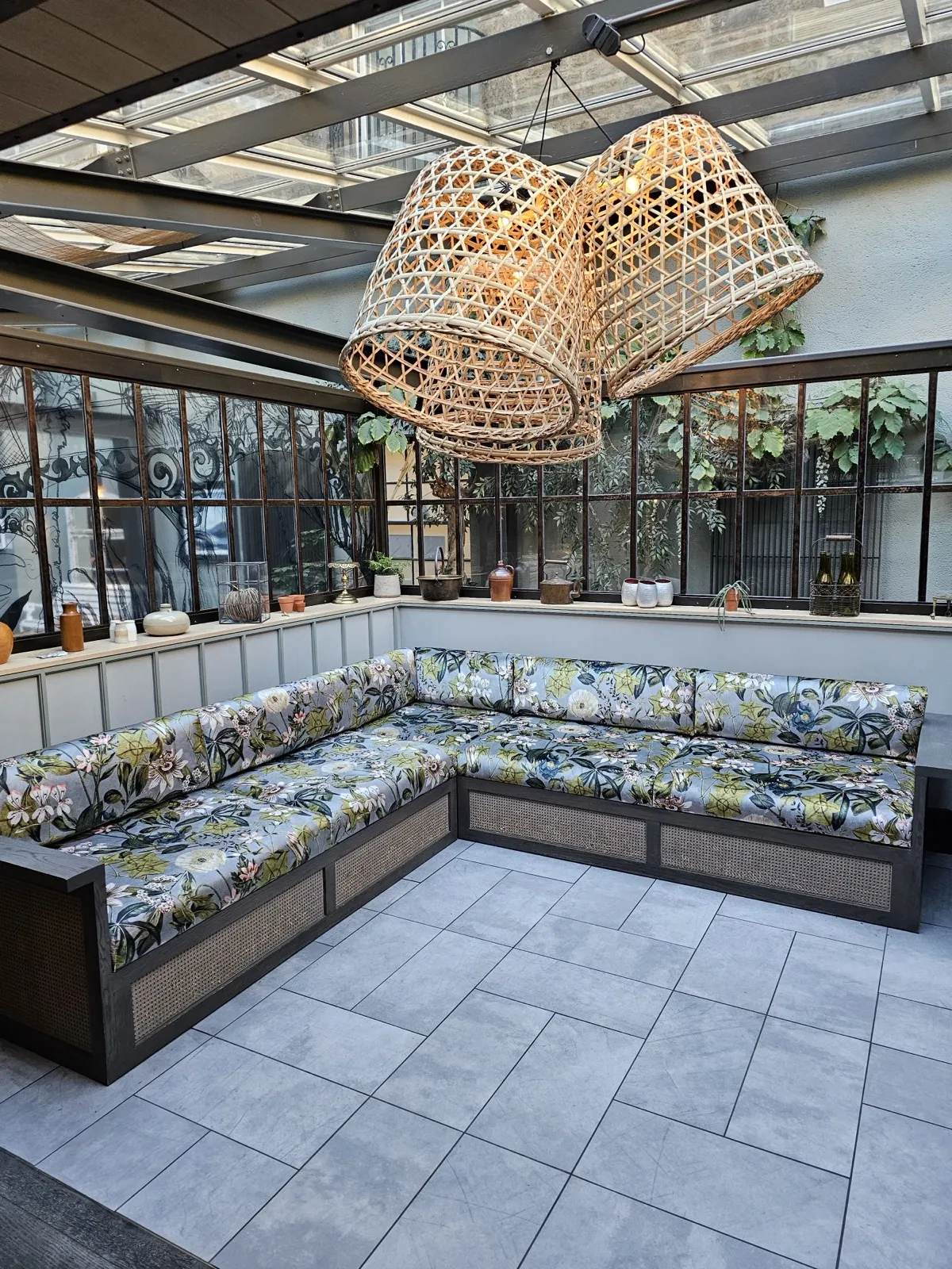 Corner banquette with floral cushions in a garden room